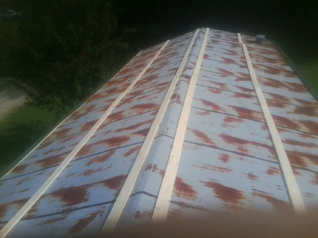Rusted metal roof panels with new wood purlins before replacement — Storm Damage Roof Repair in Kennewick by Roofing Brothers